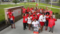 Alumni of Redford High School Detroit gather in front of a plaque commemorating the site of the now demolished campus