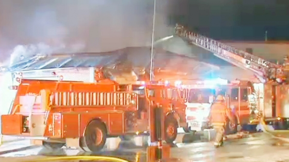 Firefighters work to extinguish flames at Dover High School