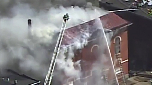 Firefighters in Baltimore work to extinguish a fire at the historic PS 103 where Supreme Court Justice Thurgood Marshall attended grade school