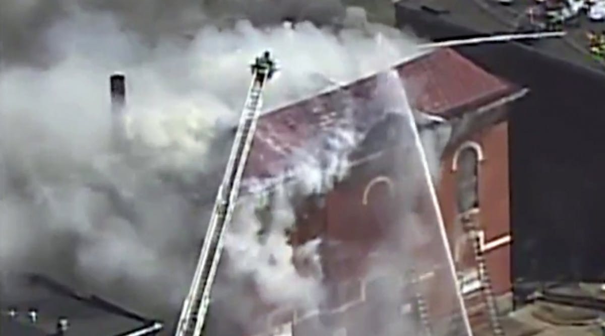 Firefighters in Baltimore work to extinguish a fire at the historic PS 103, where Supreme Court Justice Thurgood Marshall attended grade school.