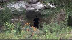 Officers search for clues in Waller Creek at the University of Texas at Austin, where a student was found slain.