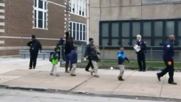 Students are escorted out of Horace Mann Elementary School in Chicago after a carbon monoxide leak