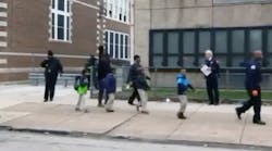 Students are escorted out of Horace Mann Elementary School in Chicago after a carbon monoxide leak.
