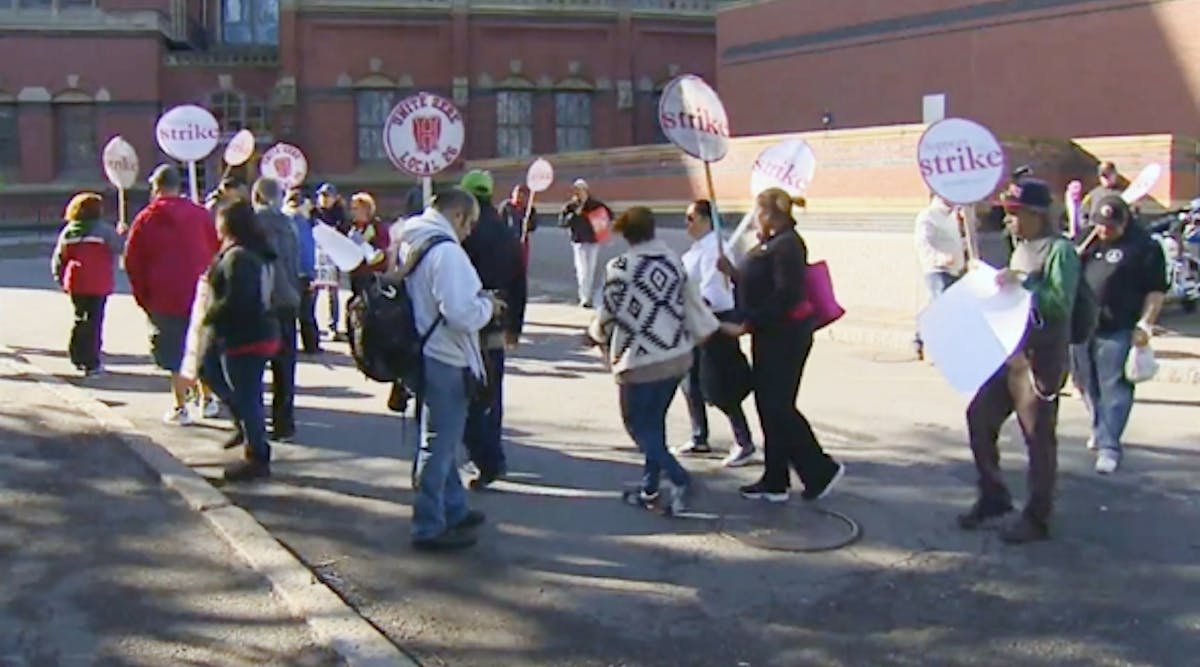Striking dining hall workers walk picket lines at Harvard University.