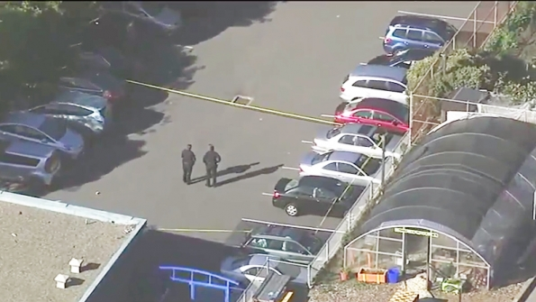 Police secure a parking lot at the June Jordan School for Equity after four students were shot