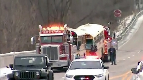 One of the school buses damaged in a crash in Indianapolis has to be towed away