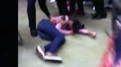 A girl at Rolesville High School in Rolesville, N.C., lies on the ground after being body-slammed by a school resource officer.