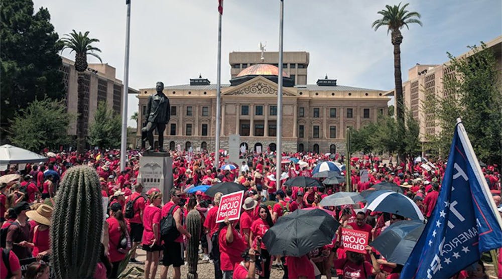 Teachers in Arizona rally for better pay outside state Capitol in Phoenix.