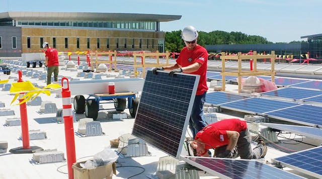 Workers install solar panels at the Truax campus of Madison Area Technical College