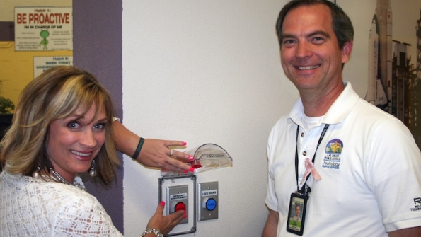 Columbia Elementary School Principal Tiffany Gomez and Technology Support Services Director Jeff Harris test the onetouch button feature which was installed this month in all Las Cruces NM Public Schools