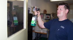 A staff member at East Meadow School District uses a green product to clean a door in this 2009 file photo. East Meadow is a previous Green Cleaning Award winner.