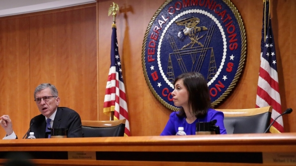 Federal Communications Commission FCC Chairman Tom Wheeler L speaks as commissioner Jessica Rosenworcel R listens during an open meeting on May 15 2014 at the FCC headquarters in Washington DC