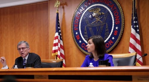 Federal Communications Commission (FCC) Chairman Tom Wheeler (L) speaks as commissioner Jessica Rosenworcel (R) listens during an open meeting on May 15, 2014 at the FCC headquarters in Washington, DC.
