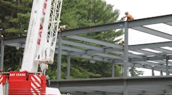 Workers put the final steel beam in place at Stonehill College&apos;s Sally Blair Ames Sports Complex.