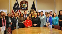 Maine Gov. Janet Mills, surrounded by tribal leaders, lawmakers, and educators, signs law banning use of Native American mascots at schools.