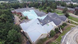 Workers install a replacement roof at the Clarkson University Recreation Center in Potsdam, New York. Workers install a replacement roof at the Clarkson University Recreation Center in Potsdam, New York.