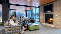 Students engaging in study break in lounge by fireplace