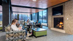 Students engaging in study break in lounge by fireplace