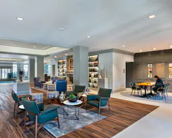 Residentially-inspired lounge area with wood flooring and comfortable seating