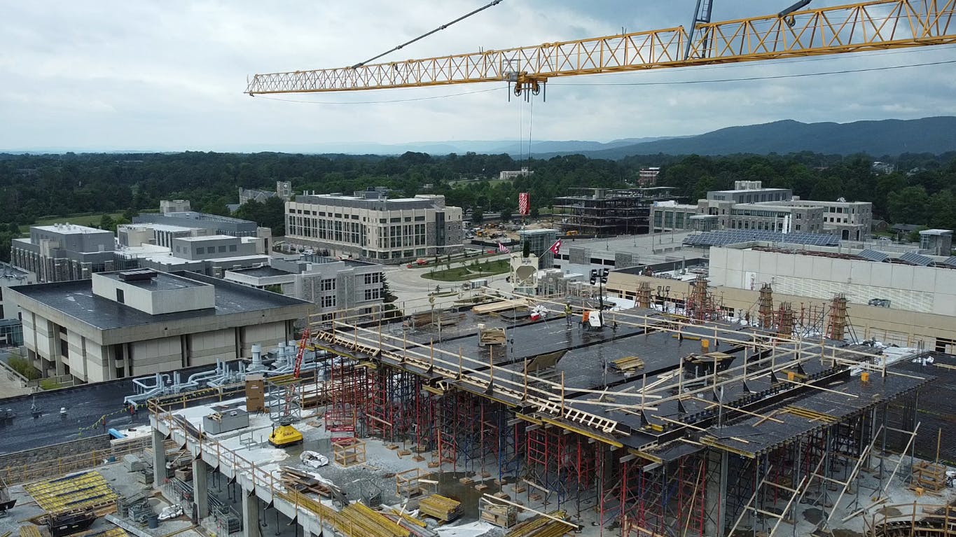 Active construction site at Virginia Tech with large crane overhead.