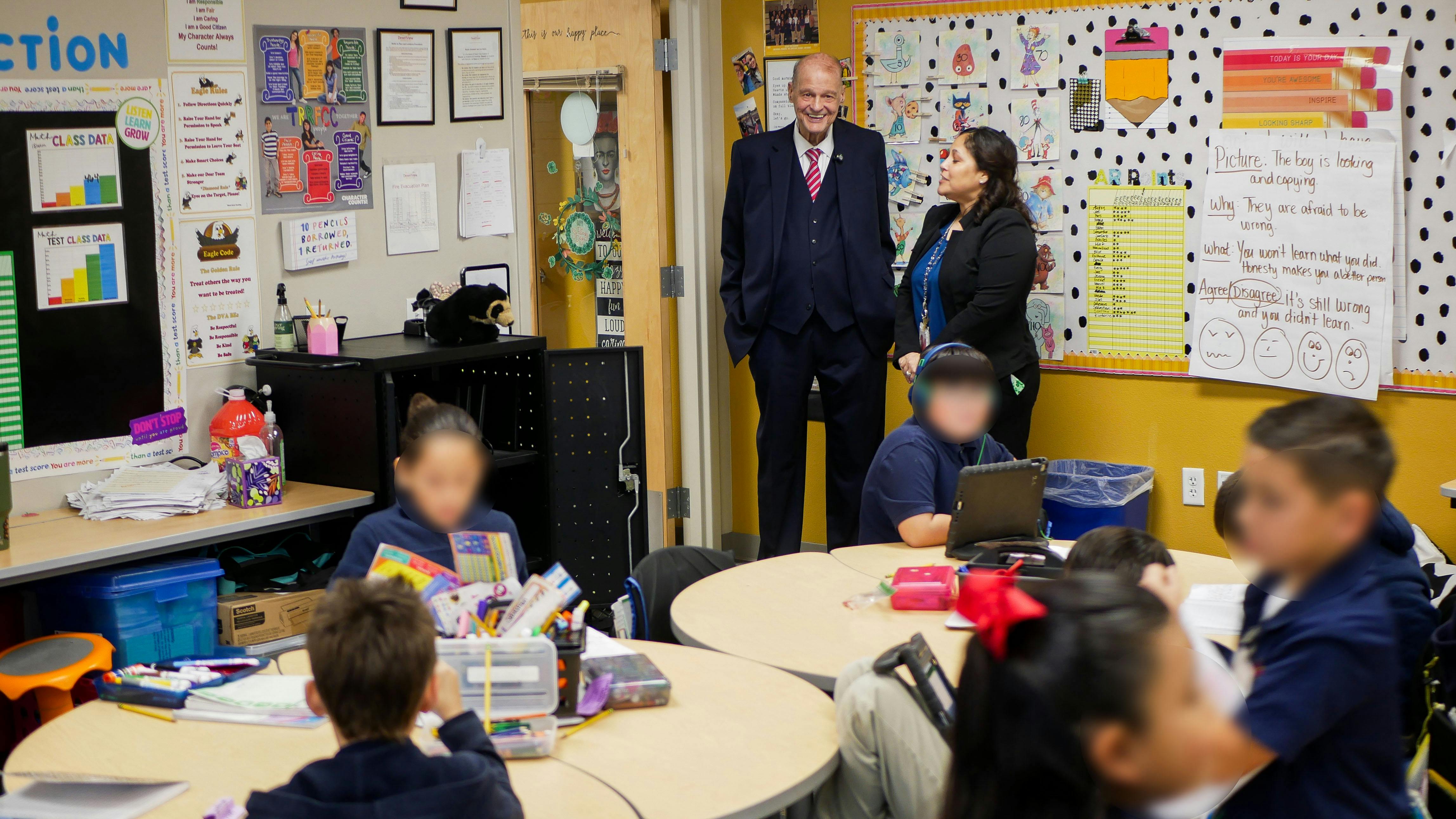 Superintendent Horn watches the busy activity of students at Desert View Academy Charter School in Yuma.