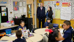 Superintendent Horn watches the busy activity of students at Desert View Academy Charter School in Yuma.
