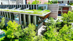 Aerial view of ducational building located on a state campus that boasts an exceptional design in sustainability and a rooftop garden that can be occupied by personnel.