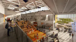 Two-story atrium with grand stair filled with students sitting beneath clerestory windows.