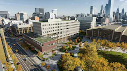 Aerial view of new physical sciences complex at University of Pennsylvania with Philadelphia skyline in background.