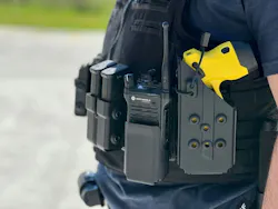 Close-up of policeman's equipment belt with taser, radio, and magazines.