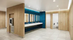 Contemporary restroom with full-height stalls in wood finish with integrated sinks in foreground against teal wall.