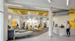 Bright, colorful reception and lounge area with students and staff engaging.