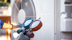 Heat and Air Conditioning, HVAC system service technician using measuring manifold gauge checking refrigerant and filling industrial air conditioner after duct cleaning maintenance outdoor compressor.