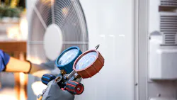 Heat and Air Conditioning, HVAC system service technician using measuring manifold gauge checking refrigerant and filling industrial air conditioner after duct cleaning maintenance outdoor compressor.