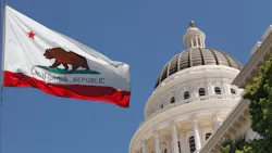 Flag of California flying outside state legislature building.