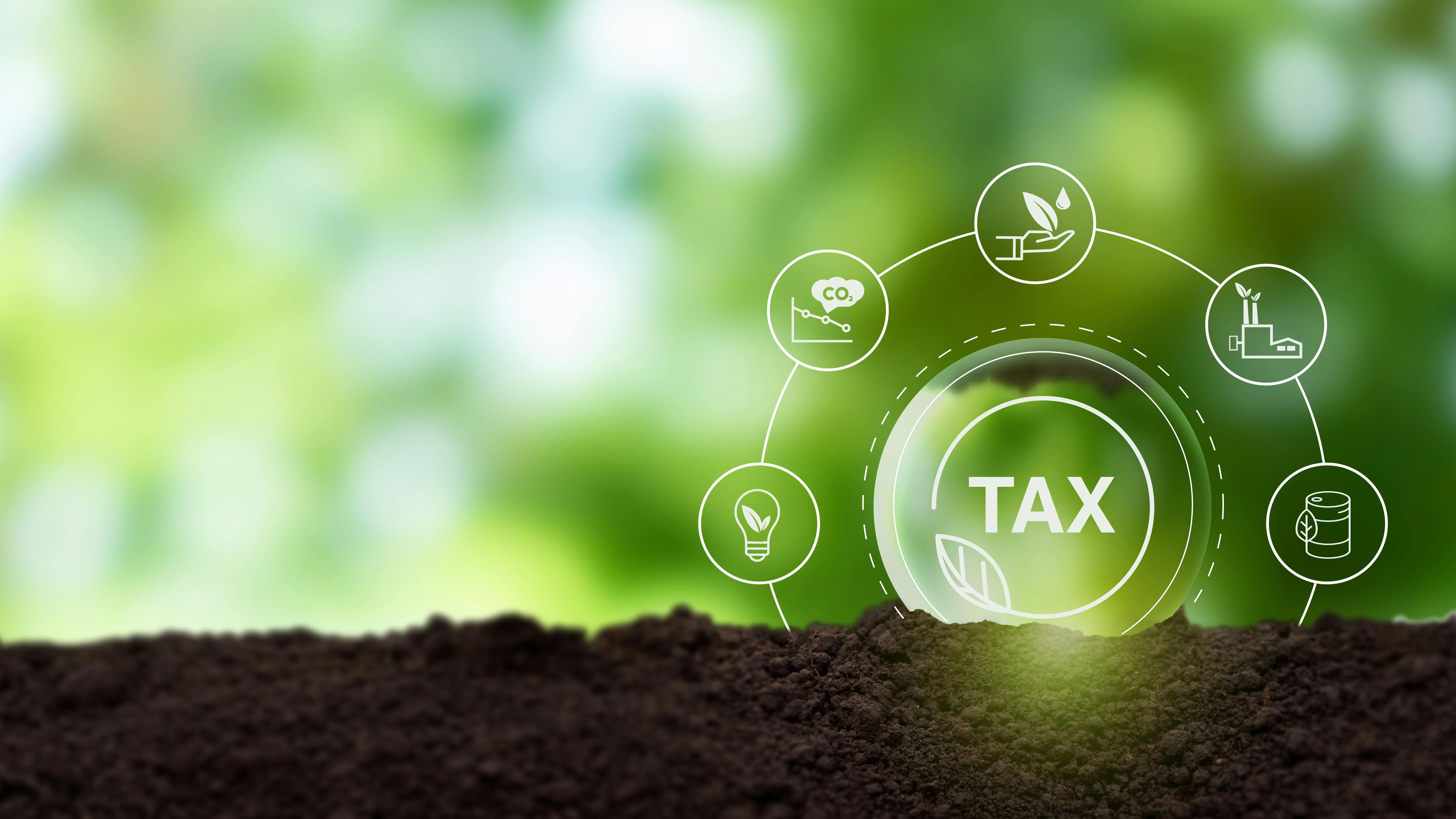 Environmental tax breaks concept. Glass ball with green taxes icons. Using environmental taxes, carbon tax, environmentally beneficial tax incentives in order to achieve environmental targets.