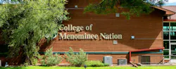 Exterior of wood building with landscaping at the College of Menominee Nation college.
