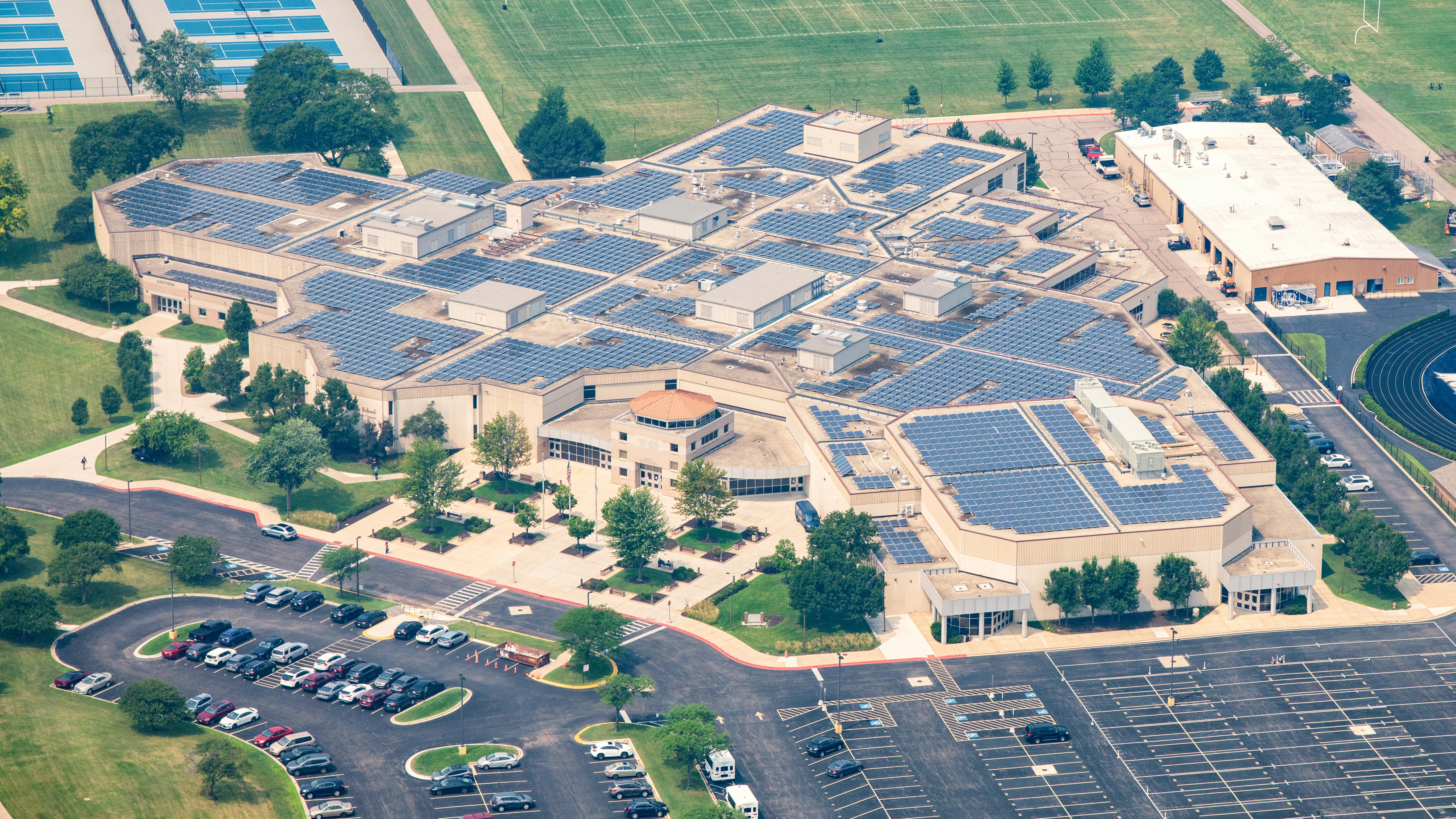 Aerial view of Lake Park High School campus with extensive solar panel array.
