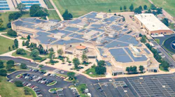 Aerial view of Lake Park High School campus with extensive solar panel array.