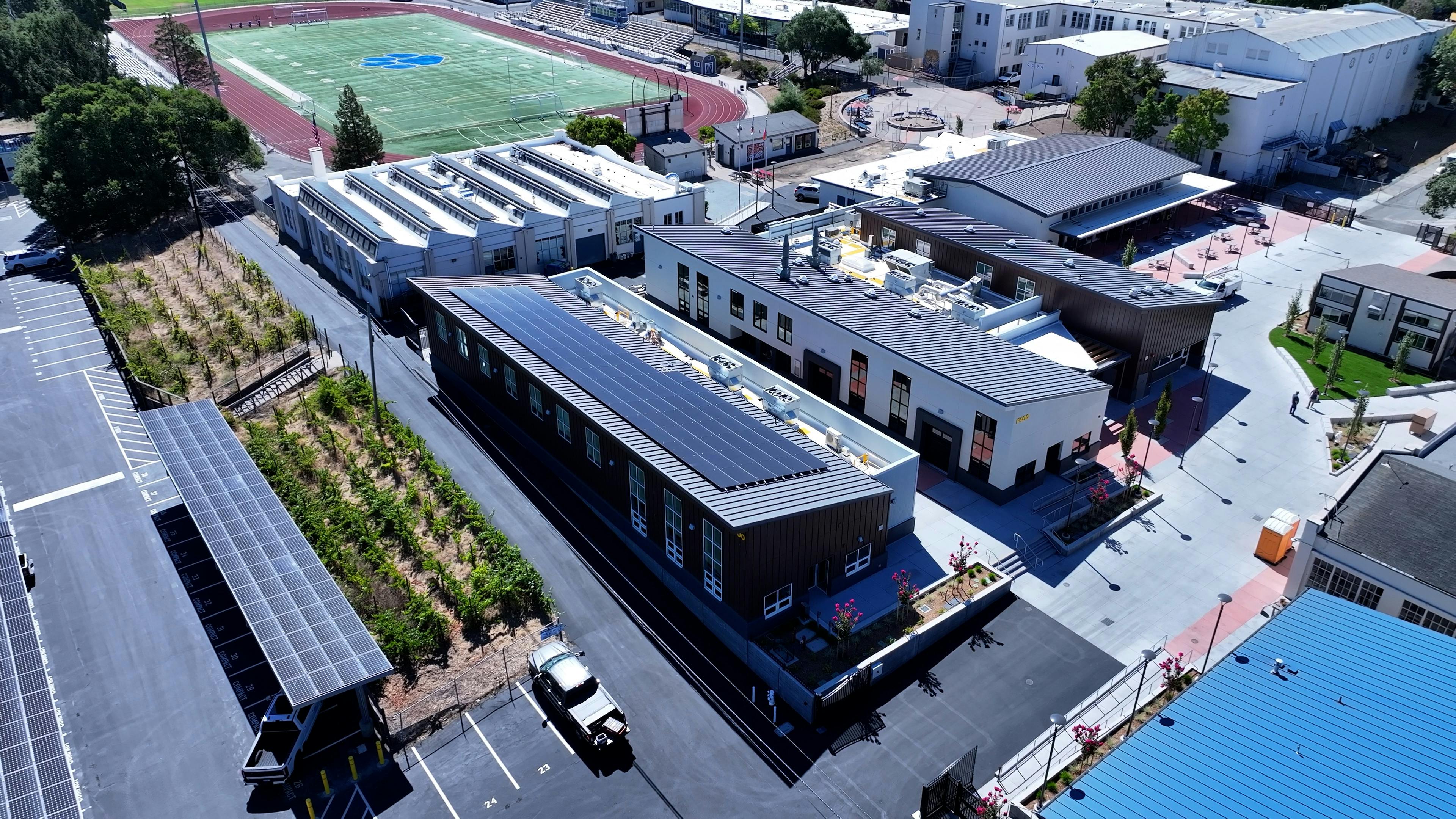 Aerial view of new career technical education center at Analy High School with solar arrays on roof.