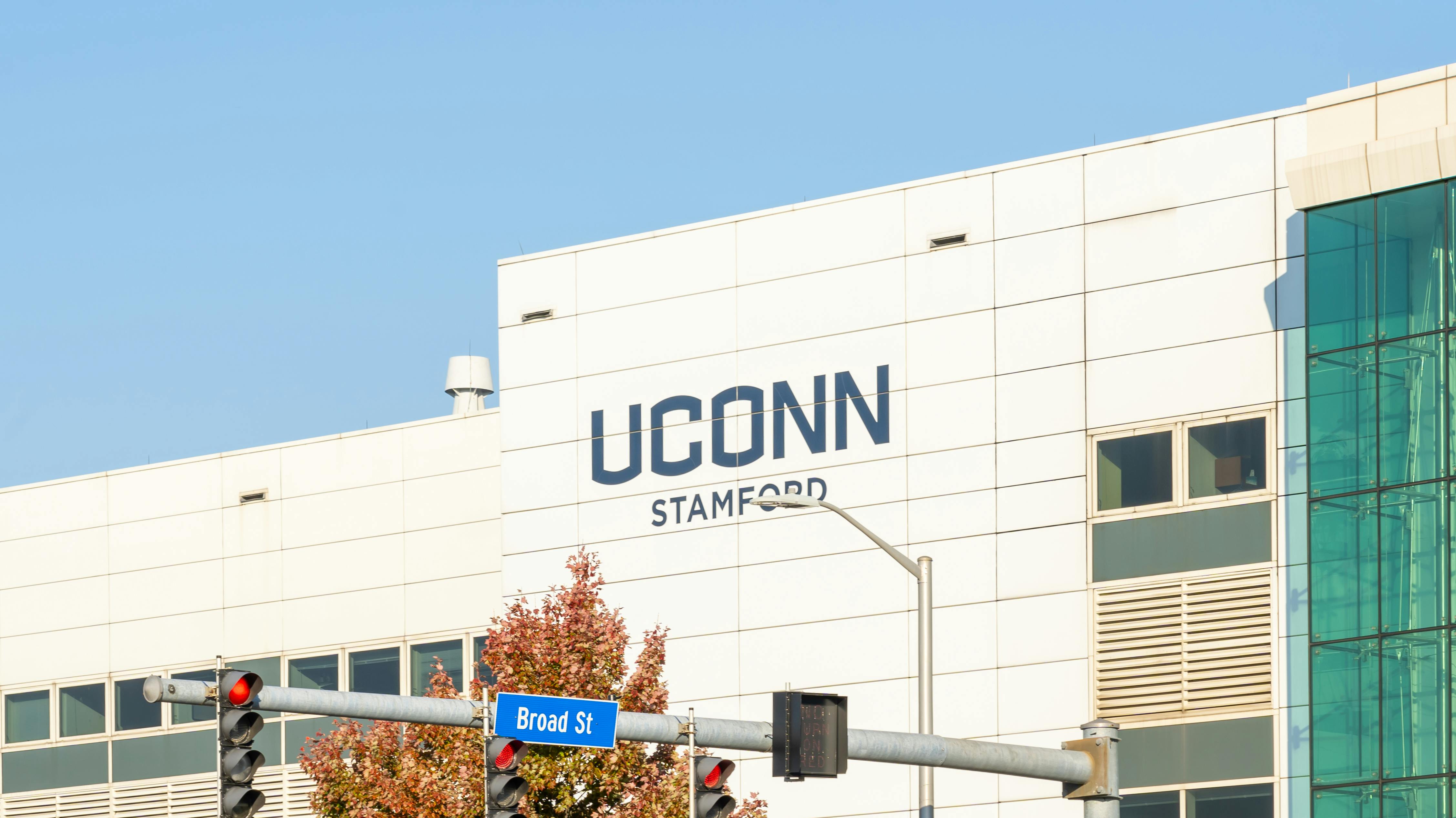 Exterior of UConn campus building with university logo.