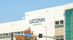 Exterior of UConn campus building with university logo.