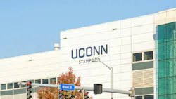 Exterior of UConn campus building with university logo.