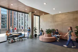 Student lounge with comfortable bench seating and access to outdoor patio space.