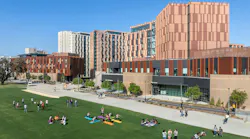 Aerial view of new mixed-use student residence hall and classroom buildings above lawn space.