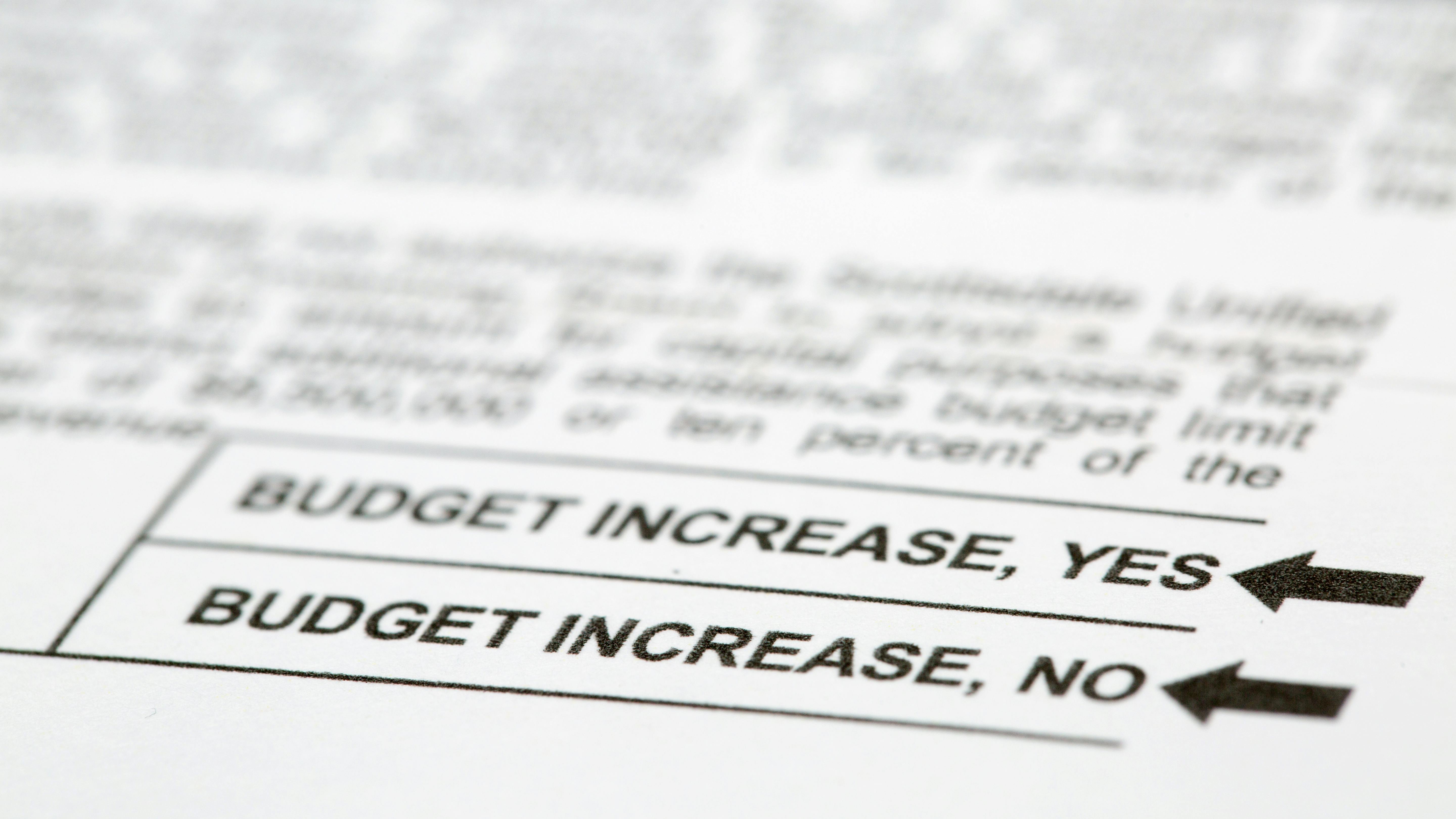 Close up of a voting ballot with a yes or no question about budget increases.