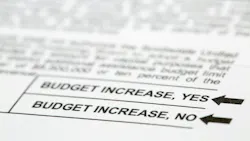 Close up of a voting ballot with a yes or no question about budget increases.